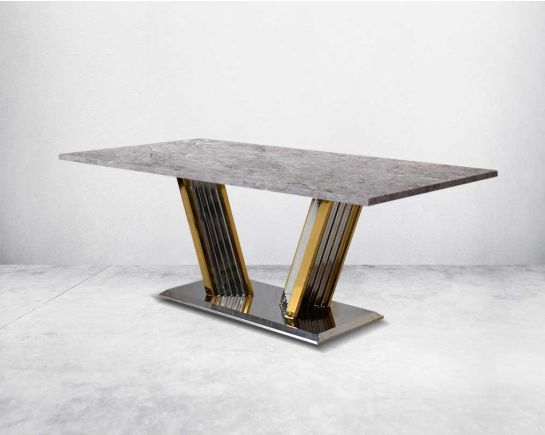 This glorious grey marble top dining table features a tree bark design motif and is crafted with a glossy gold-plated fluted stainless steel base.