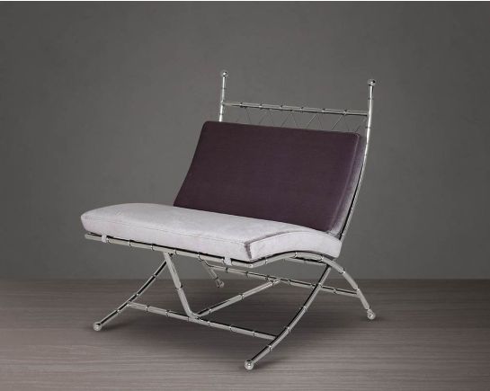 Lounge chair upholstered in fabric with high polished stainless steel frame in bamboo design.
