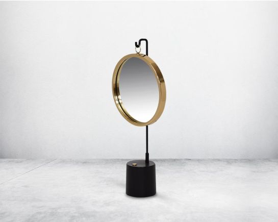 Round table dresser mirror suspended on a hook in shiny antique brass & matt black finished base. The look is very retro modern.