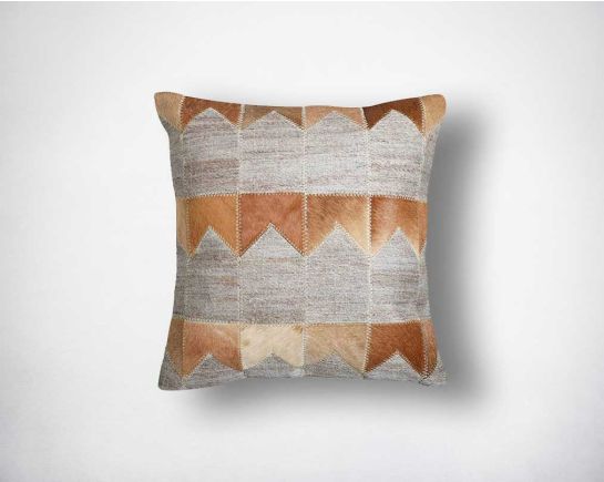 Beige, grey and tan cut-out fabric and leather hair on the cushion.