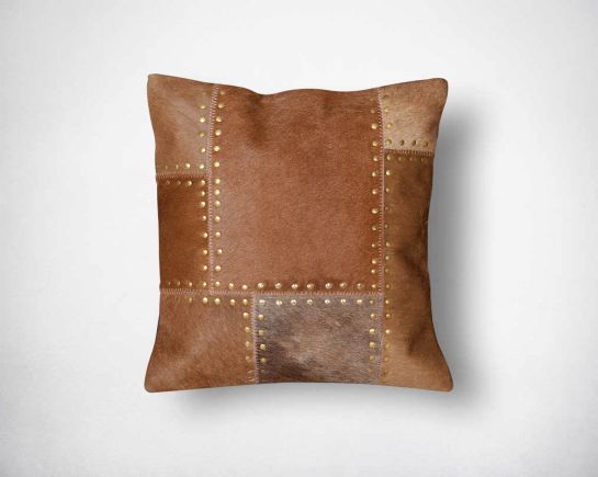 Brown hair on leather cushion with gold rivets.
