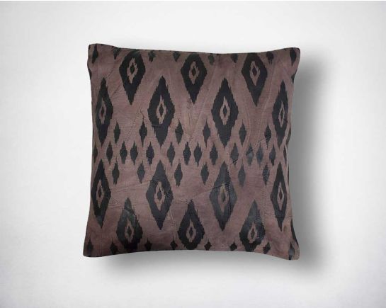 Leather cushion with eye print.