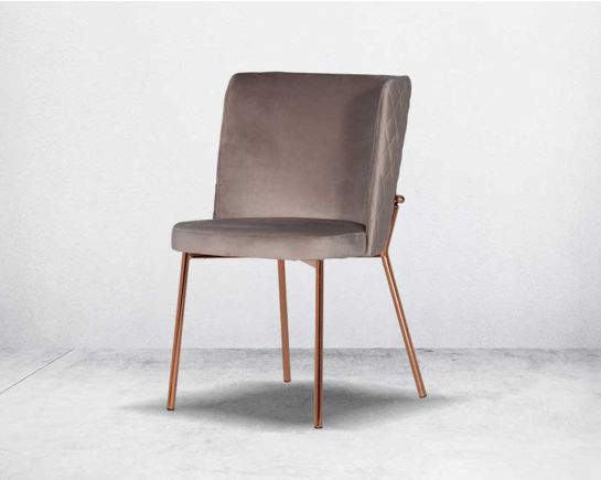 Minimalistically designed chair with criss-cross stitch padded fabric in rose gold finish stainless steel legs in contemporary design.