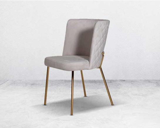 Minimalistically designed chair with criss-cross stitch padded fabric in gold finish stainless steel legs in contemporary design.