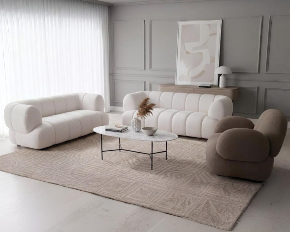 This sinuous & soft 3+2 seater sofa exudes a sense of calm & ease, upholstered in high-quality boucle fabric with wooden legs.